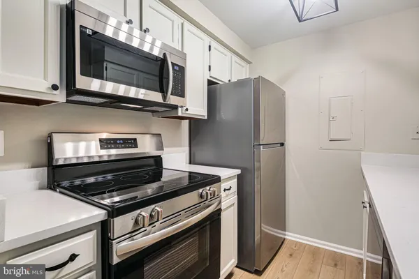 a kitchen with wooden cabinets and stainless steel appliances