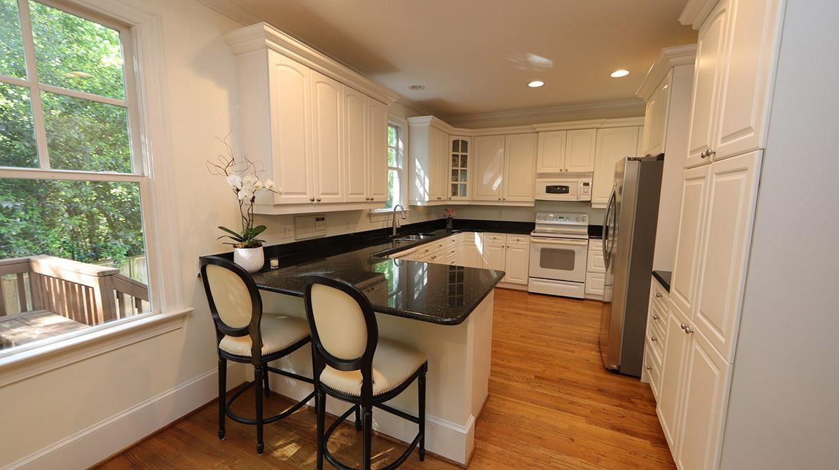 124 Village Mill Place Raleigh, NC 27608 - Photo 11 of 30 Light and bright with beautiful granite counters and pantry large enough for another mid size refrigerator. Kitchen