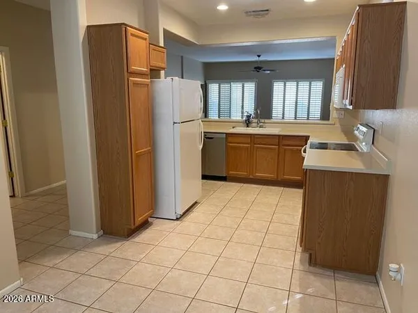a kitchen with stainless steel appliances a refrigerator sink and cabinets