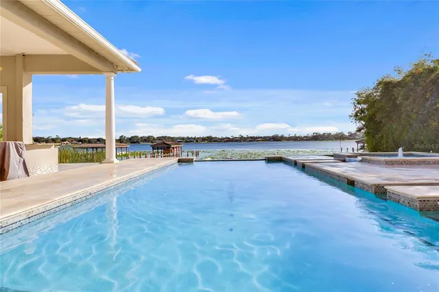 a view of a dining room with furniture wooden floor and a chandelier