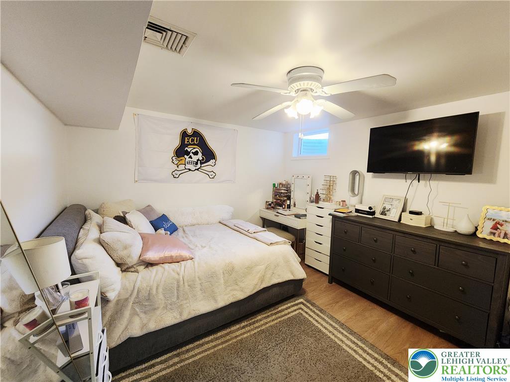 237 Ridings Circle Macungie, PA 18062 - Photo 61 of 70 Smooth wood floors anchor this cozy bedroom space under a flat white ceiling.