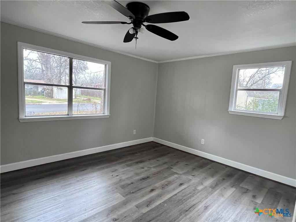 1201 South 21st Street Temple, TX 76504 - Photo 12 of 15 a view of an empty room with wooden floor and a window