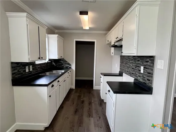 a kitchen with a stove and a refrigerator