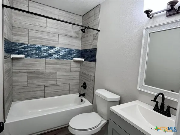 a bathroom with a sink a toilet and bathtub