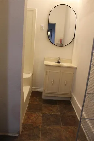 a bathroom with a sink and a mirror