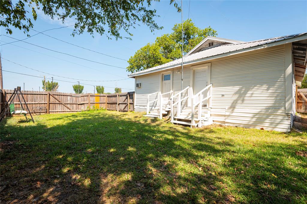 1909 Sycamore Street Commerce, TX 75428 - Photo 20 of 26 a house view with swimming pool in front of it