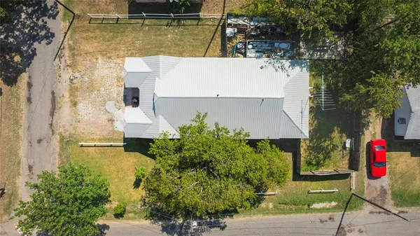an aerial view of a house with a yard basket ball court and outdoor seating
