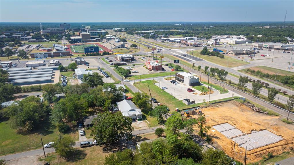 1909 Sycamore Street Commerce, TX 75428 - Photo 22 of 26 an aerial view of residential building and parking space