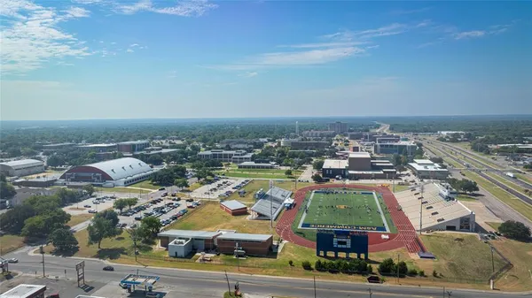 an aerial view of residential houses with outdoor space