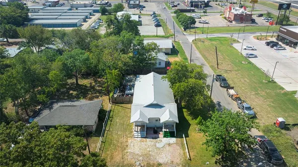 an aerial view of a house with a garden and lake view