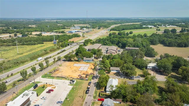 an aerial view of residential houses with outdoor space and river