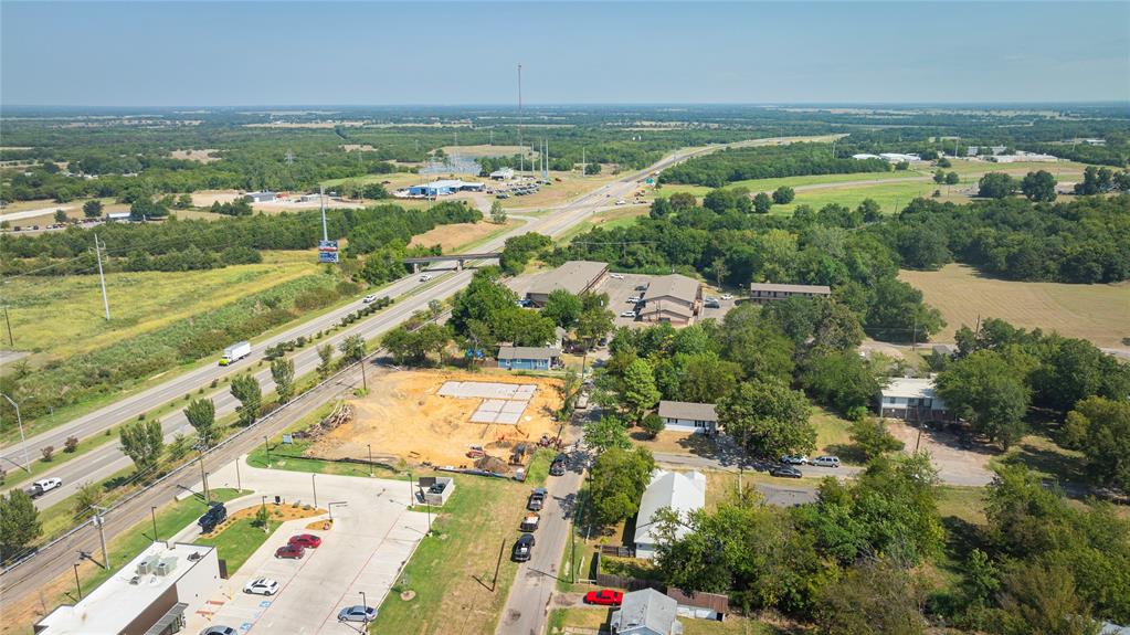 1909 Sycamore Street Commerce, TX 75428 - Photo 25 of 26 an aerial view of residential houses with outdoor space and river
