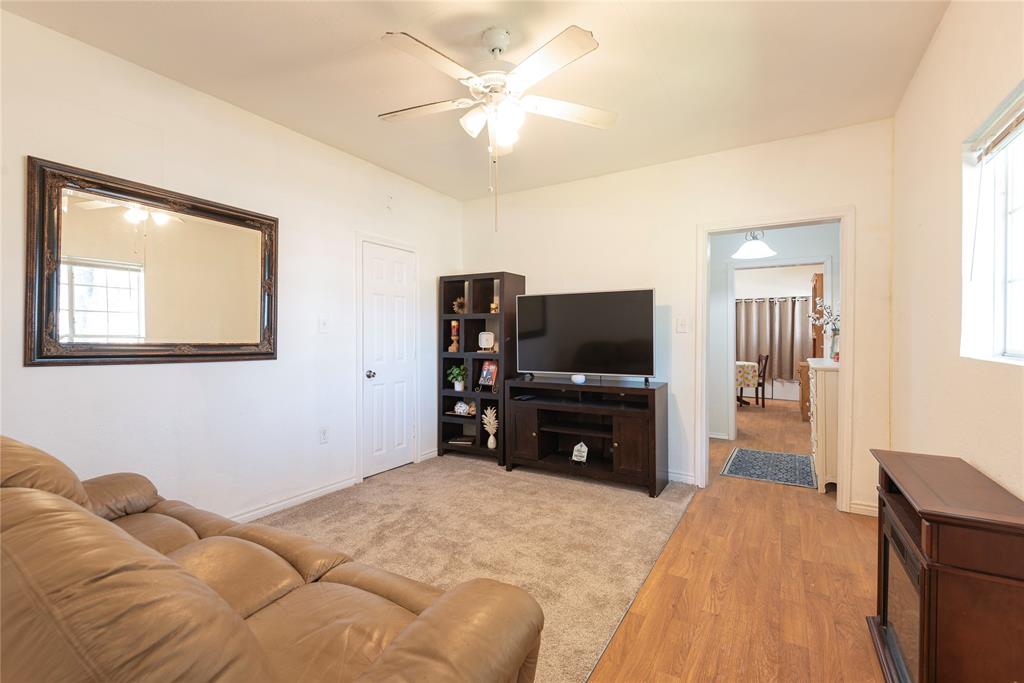 1909 Sycamore Street Commerce, TX 75428 - Photo 4 of 26 a bedroom with a bed and a flat screen tv