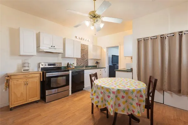 a kitchen with stainless steel appliances a stove a sink dishwasher and a refrigerator