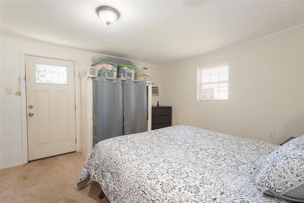 1909 Sycamore Street Commerce, TX 75428 - Photo 9 of 26 a bedroom with a bed and a window