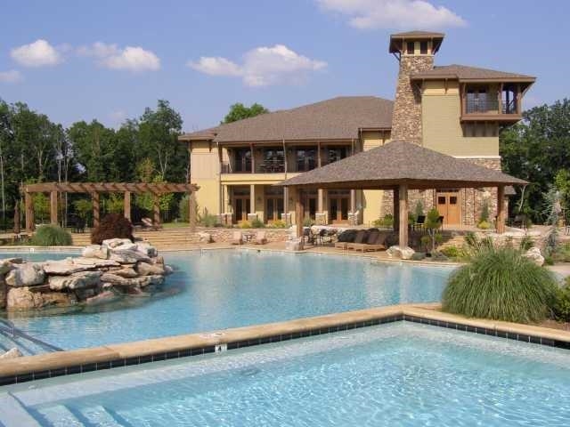 106 Gentle Ridge Way Savannah, TN 38372 - Photo 2 of 9 a view of a house with pool and chairs