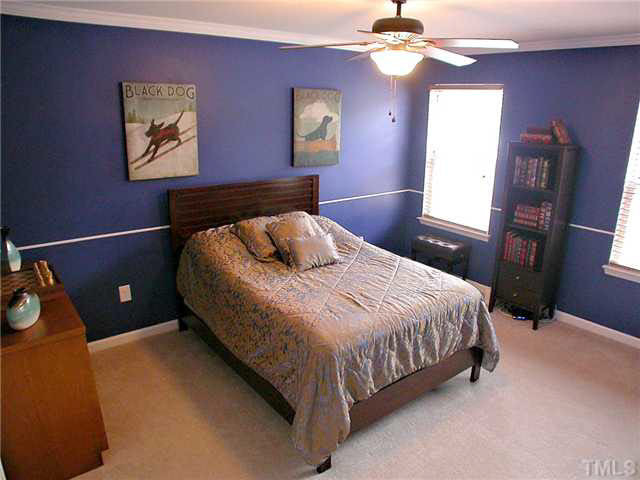 21 Kissimee Court Durham, NC 27713 - Photo 13 of 25 a bedroom with a bed and a chandelier
