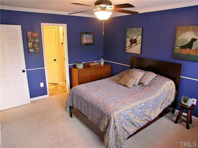 21 Kissimee Court Durham, NC 27713 - Photo 14 of 25 a bedroom with a bed and a chandelier