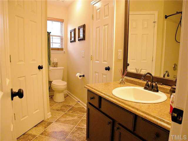 21 Kissimee Court Durham, NC 27713 - Photo 16 of 25 a bathroom with a sink a toilet and shower