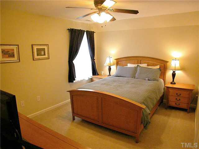 21 Kissimee Court Durham, NC 27713 - Photo 18 of 25 a bedroom with a bed and a chandelier