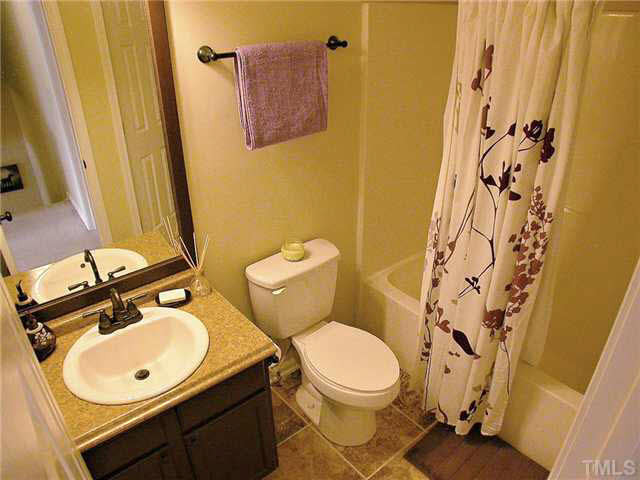21 Kissimee Court Durham, NC 27713 - Photo 19 of 25 a bathroom with a sink mirror vanity and toilet