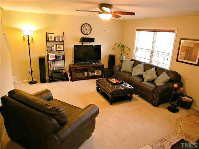21 Kissimee Court Durham, NC 27713 - Photo 2 of 25 a living room with furniture a flat screen tv and a window