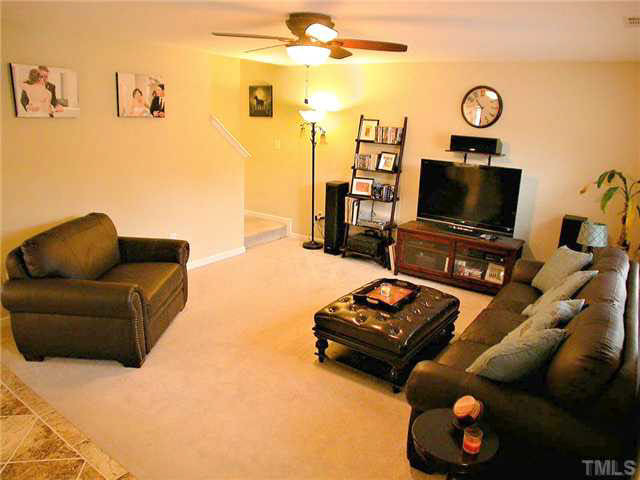 21 Kissimee Court Durham, NC 27713 - Photo 5 of 25 a living room with furniture and a flat screen tv with kitchen view