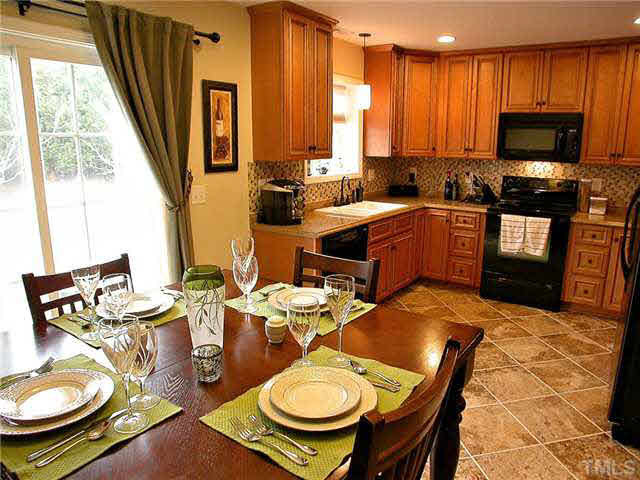 21 Kissimee Court Durham, NC 27713 - Photo 8 of 25 a kitchen with a table chairs stove and kitchen view