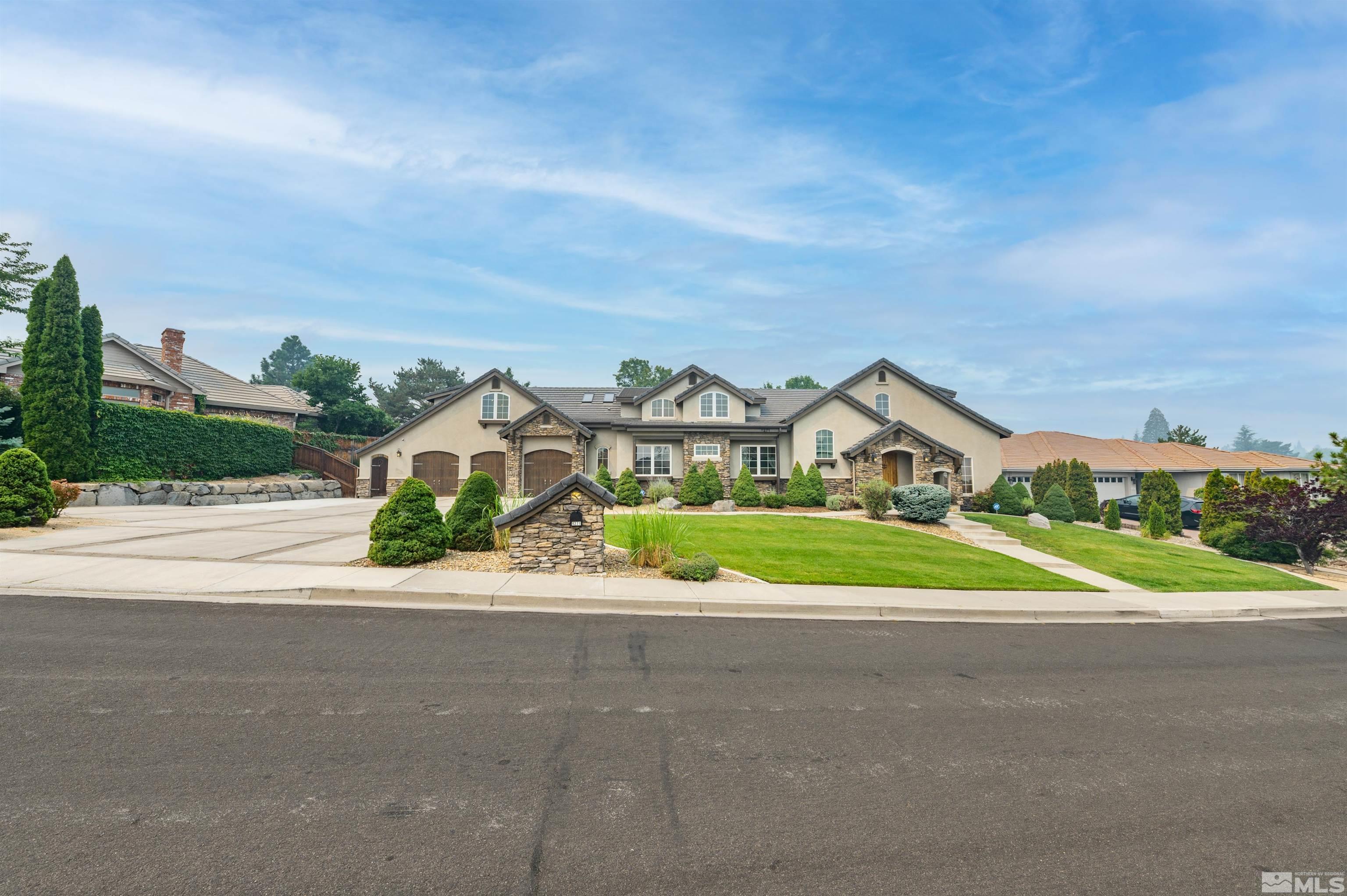 a front view of a house with a yard and road