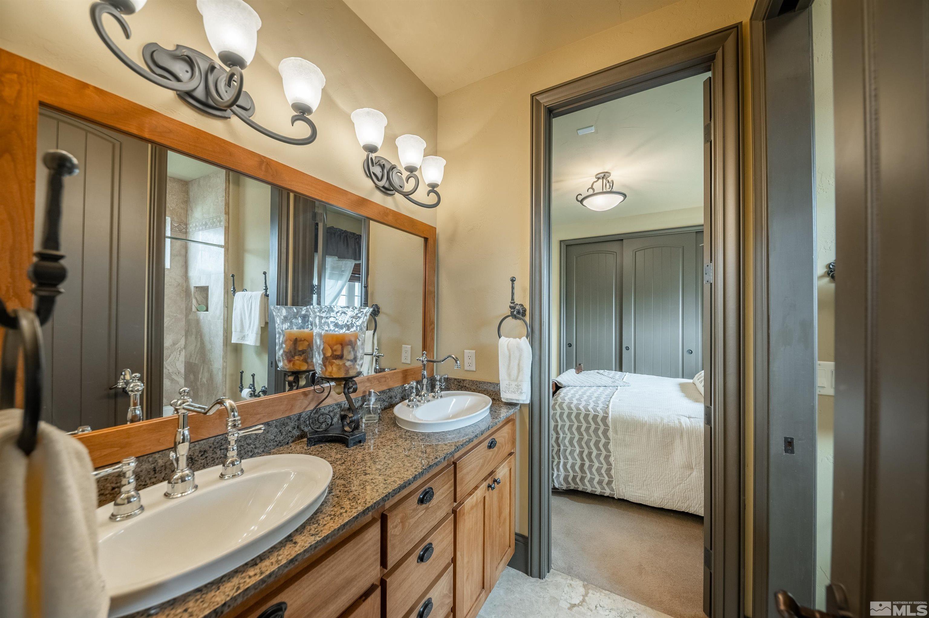 4271 Dant Boulevard Reno, NV 89509 - Photo 12 of 24 a en suite bathroom with a double vanity sink and a mirror