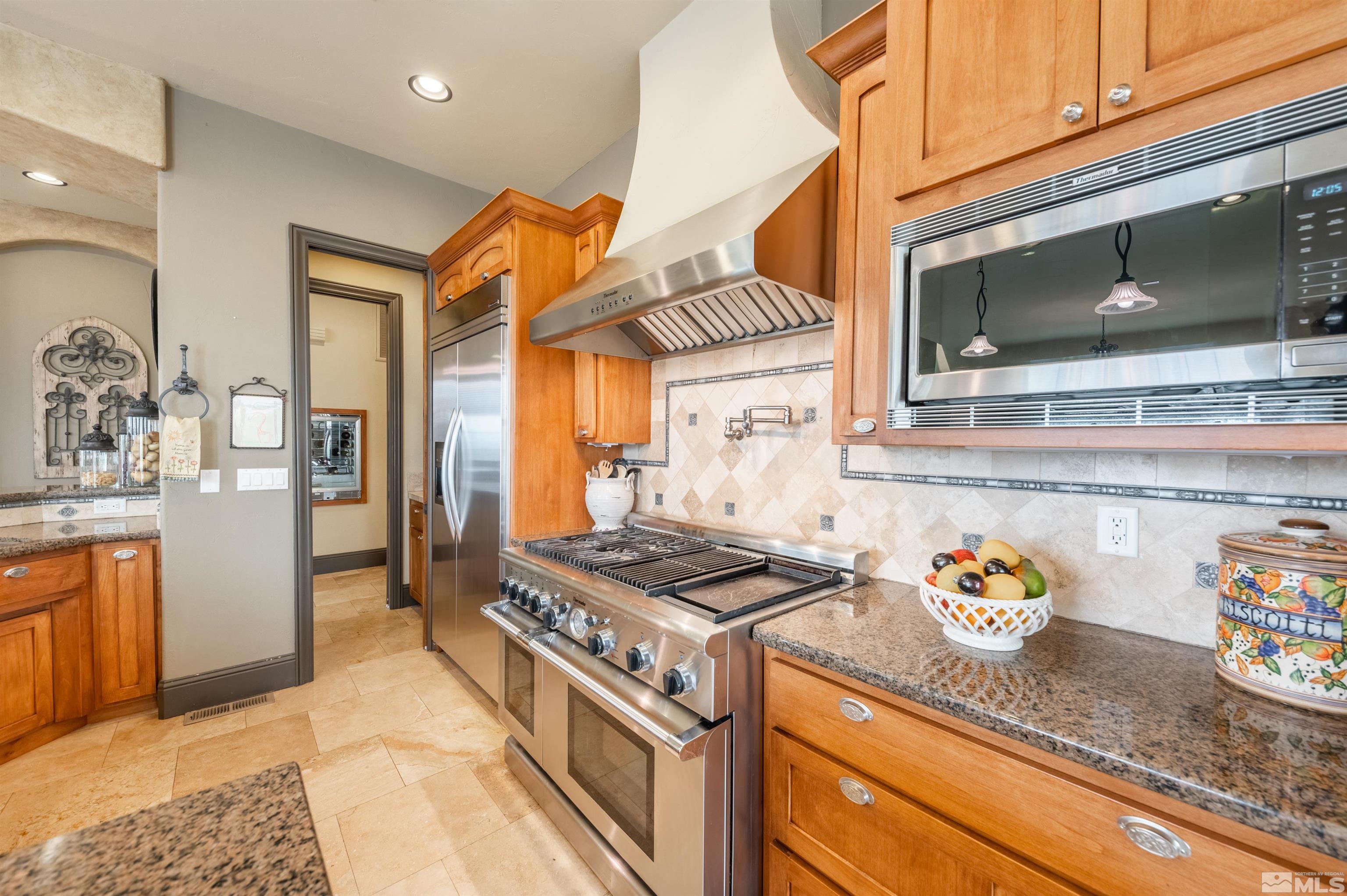 4271 Dant Boulevard Reno, NV 89509 - Photo 5 of 24 a kitchen with stainless steel appliances granite countertop a sink stove and cabinets