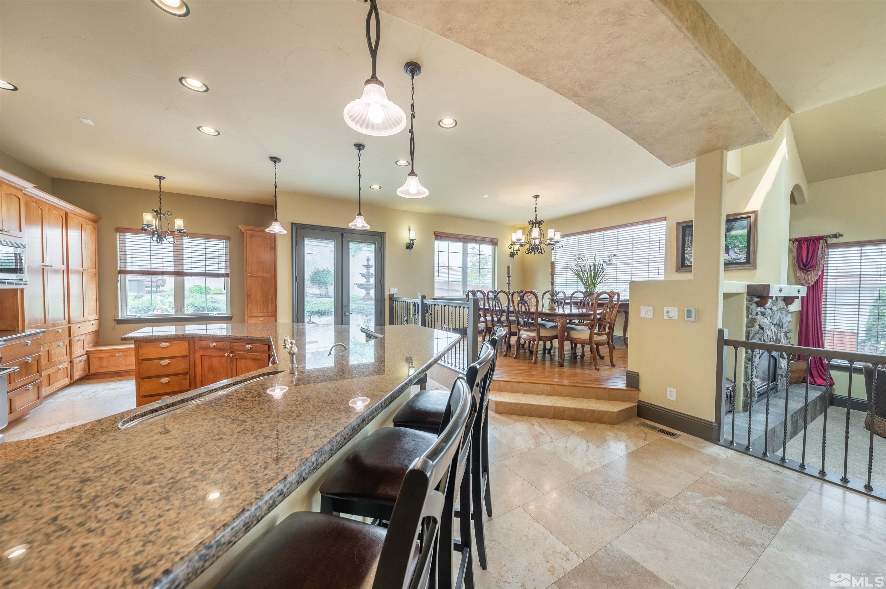4271 Dant Boulevard Reno, NV 89509 - Photo 6 of 24 a dining hall with stainless steel appliances kitchen island granite countertop a table and chairs