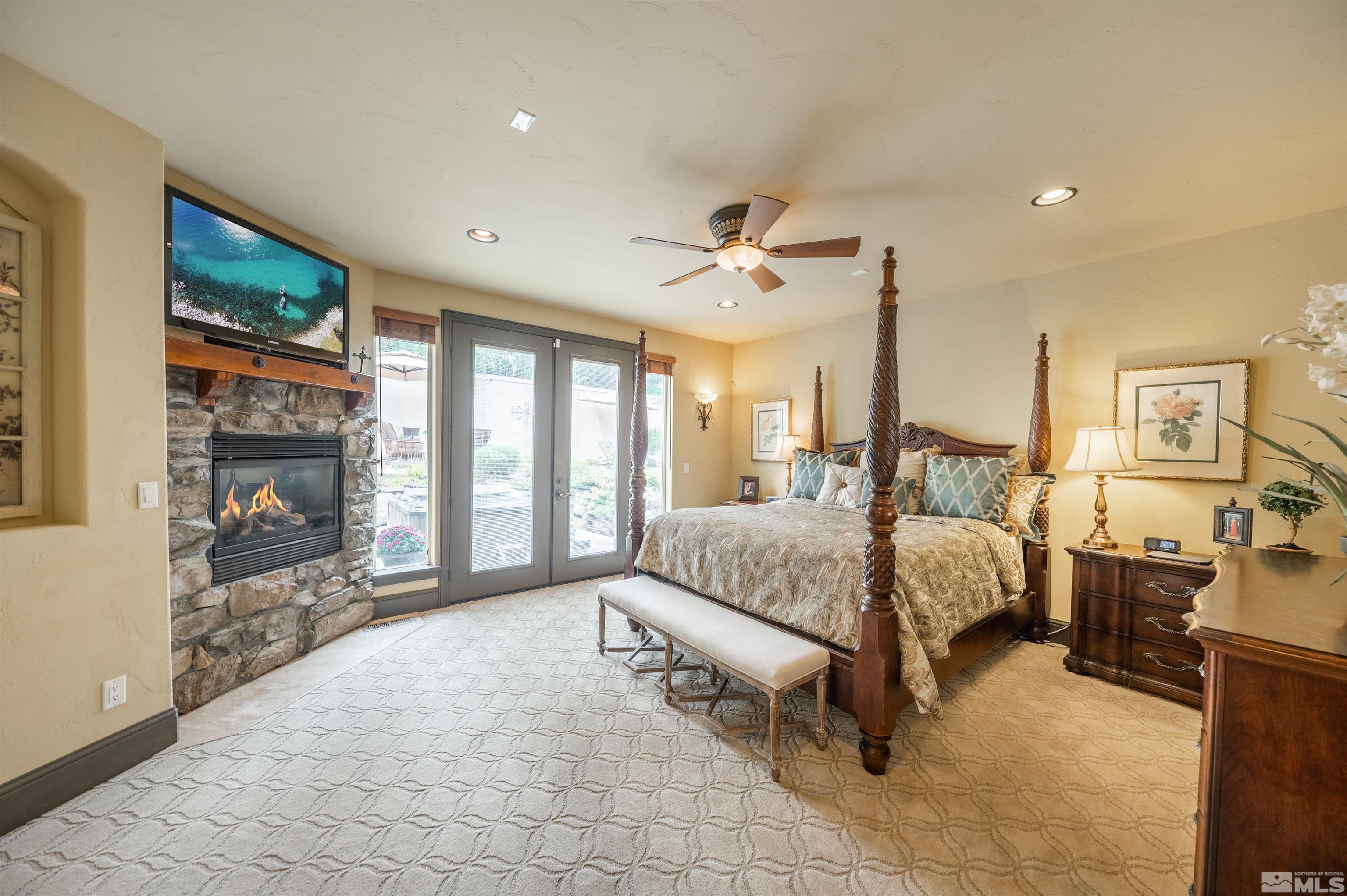 4271 Dant Boulevard Reno, NV 89509 - Photo 8 of 24 a spacious bedroom with a large bed and a chandelier