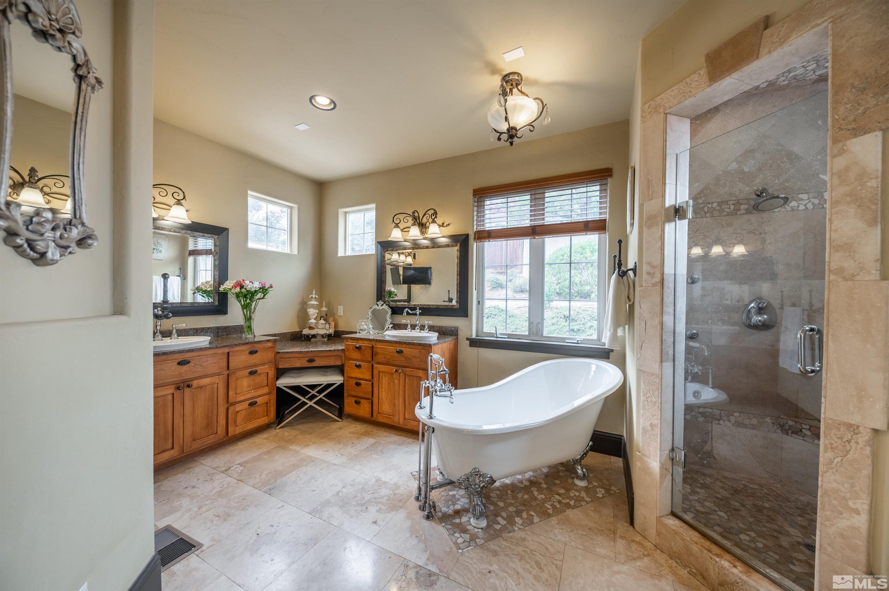 4271 Dant Boulevard Reno, NV 89509 - Photo 10 of 24 a spacious bathroom with a bathtub shower and toilet