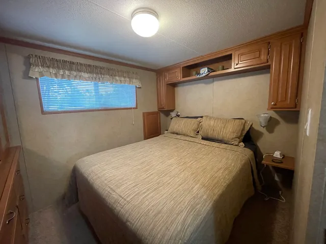 a bedroom with a bed and a window