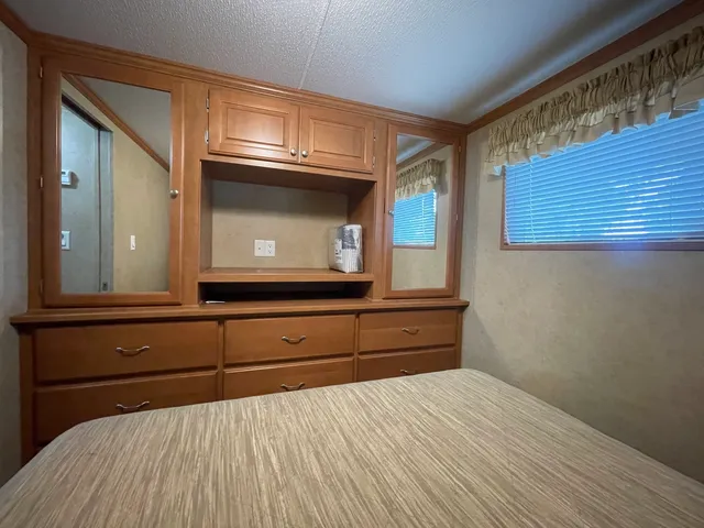 a bedroom with a bed and a television