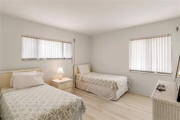 a bedroom with two beds and a window