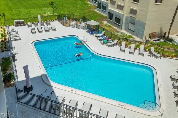 a view of a swimming pool with outdoor seating and plants
