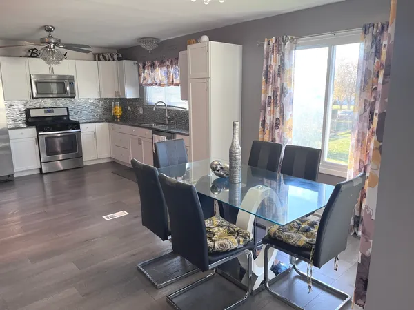 a view of a dining room with furniture window and wooden floor