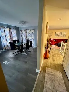 a bedroom with a bed a mirror on the dresser and floor