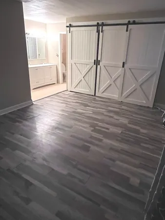 a view of a room with wooden floor and window