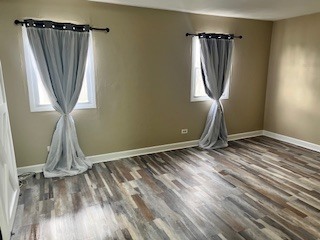56 Timberlane Road Matteson, IL 60443 - Photo 27 of 40 a view of empty room with wooden floor and fan