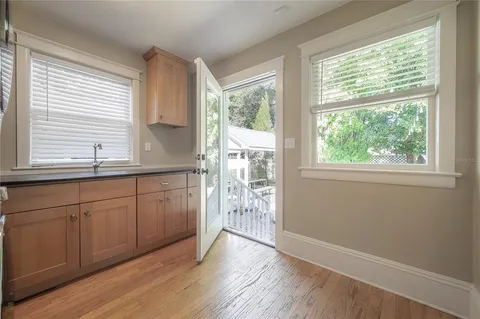 a kitchen with stainless steel appliances granite countertop wooden floors and sink