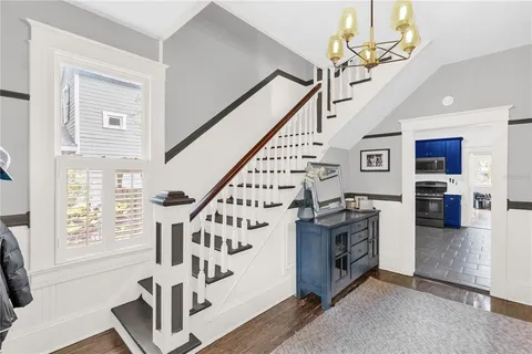 a view of entryway and hall with wooden floor