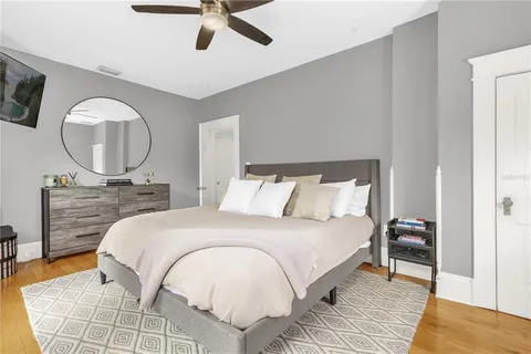 a bedroom with a bed and a mirror