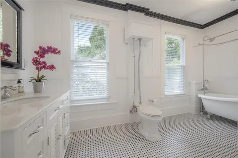a bathroom with a sink a toilet and shower