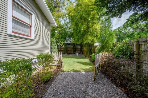 a view of a chair and table in backyard of the house