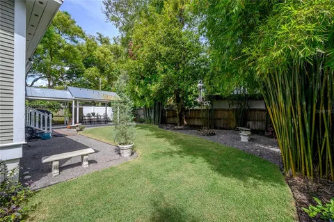 a view of a patio with a table chairs and a backyard