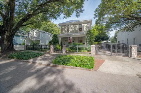 a front view of house with yard green space and outdoor seating