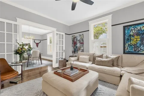 a living room with furniture and a potted plant